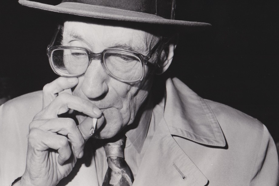 William Burroughs in fedora hat smoking marijuana in Chicago Oct 20 1988 - photo by Richard Alm